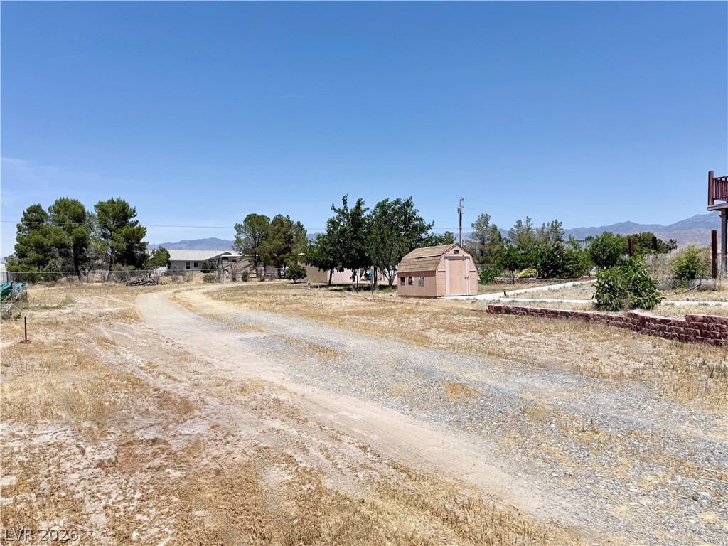 1220 East Gamebird Road Pahrump, NV 89048 - Photo 22 of 49 A spacious desert property offering a clear, open sky and distant mountain views.