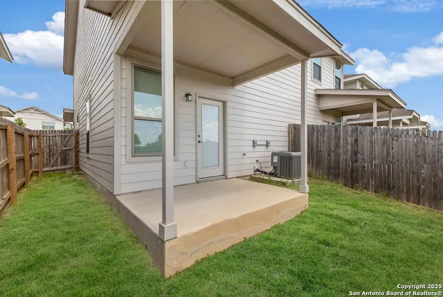 a view of a backyard with a large tree