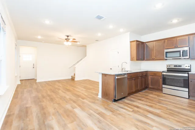 a kitchen with a sink cabinets and wooden floor
