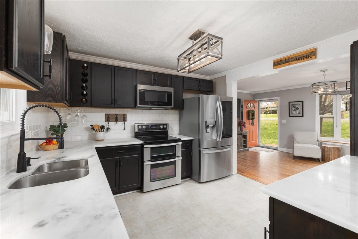 922 Potter Lane Nashville, TN 37206 - Photo 11 of 42 a kitchen with stainless steel appliances granite countertop a refrigerator stove top oven and sink