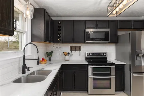 a kitchen with a sink stove and microwave