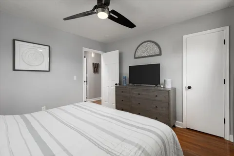 a bedroom with a bed and a flat screen tv
