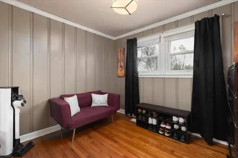 a living room with furniture a wooden floor and a window