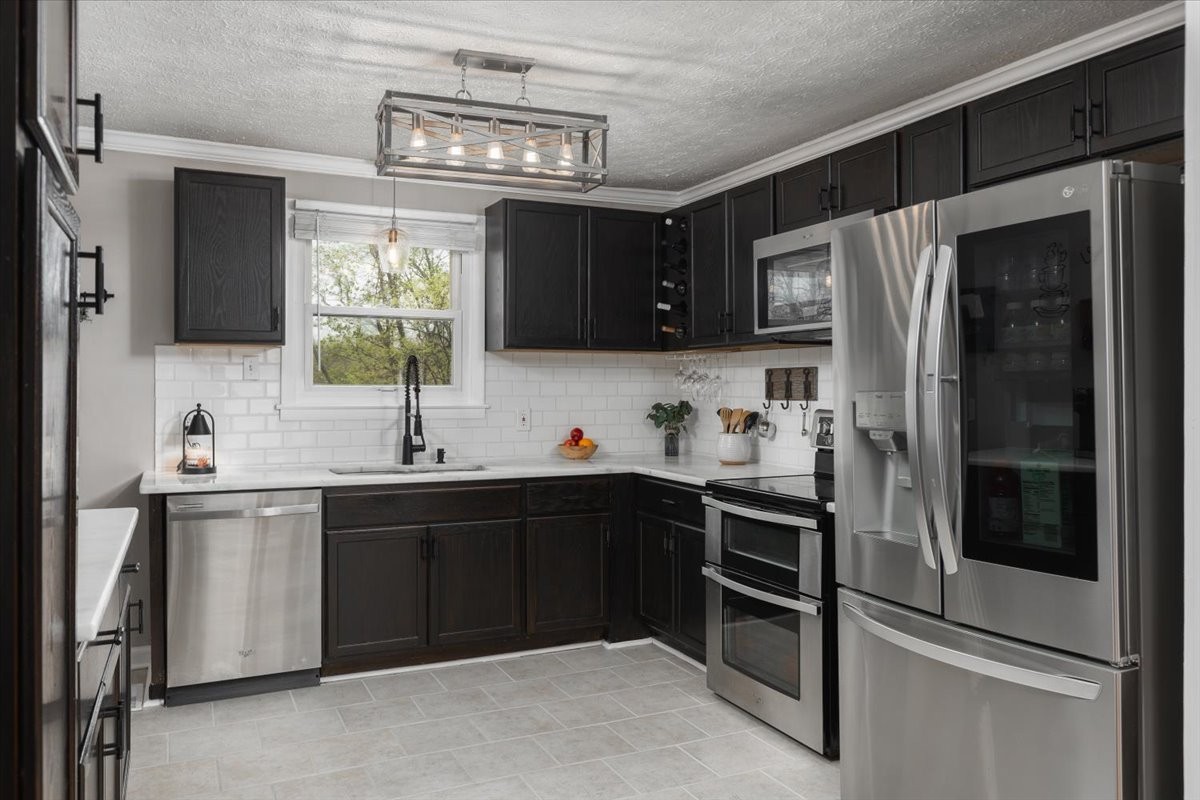 922 Potter Lane Nashville, TN 37206 - Photo 9 of 42 a kitchen with a sink stainless steel appliances and cabinets