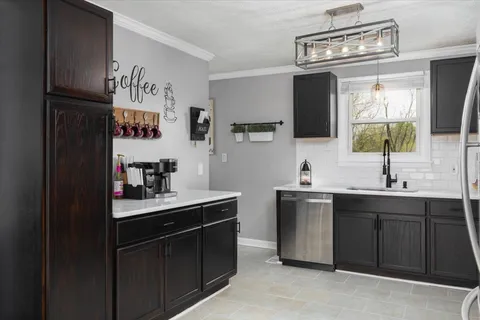 a kitchen with a sink and cabinets