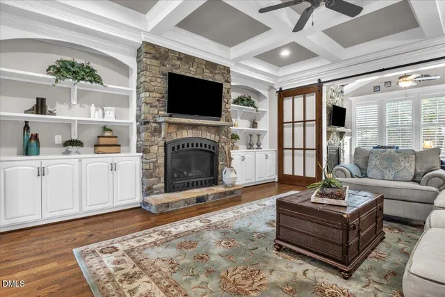 a living room with furniture flat screen tv and gym equipment