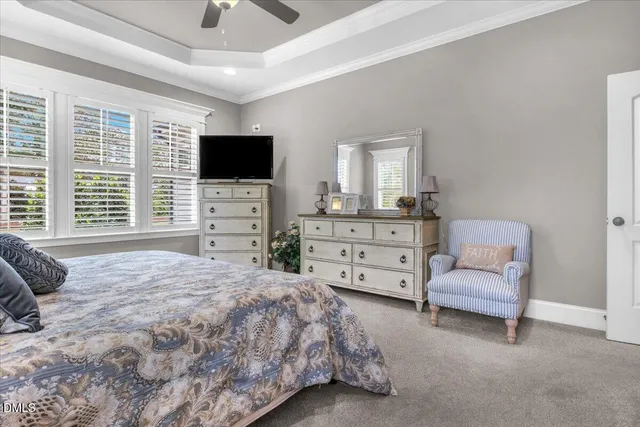 a view of an empty room with furniture and a flat screen tv