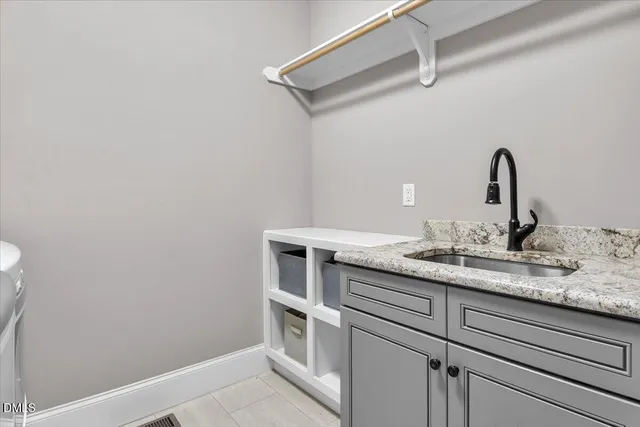 front view of house with a yard and potted plants