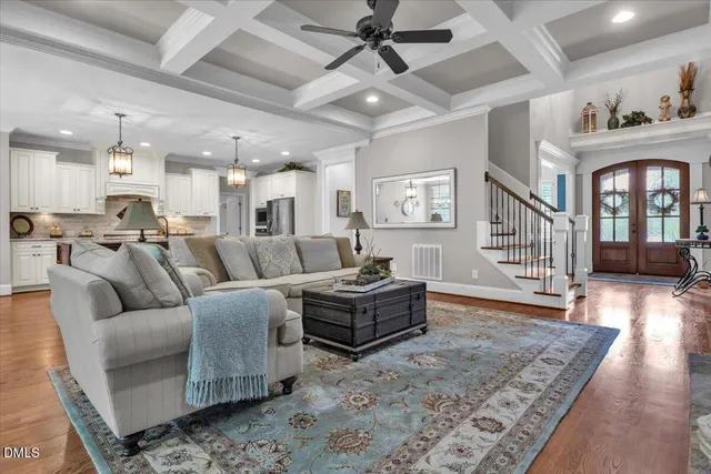 a kitchen with stainless steel appliances granite countertop a kitchen island a stove a refrigerator a oven a sink with a dining table and chairs