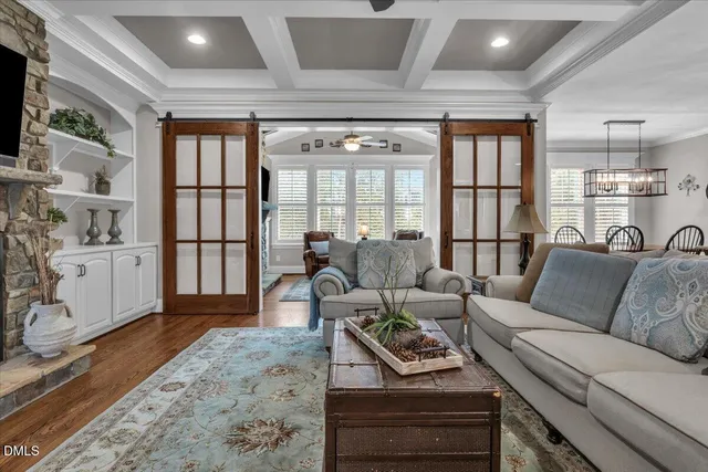 a kitchen with granite countertop a stove a sink dishwasher and cabinets with wooden floor