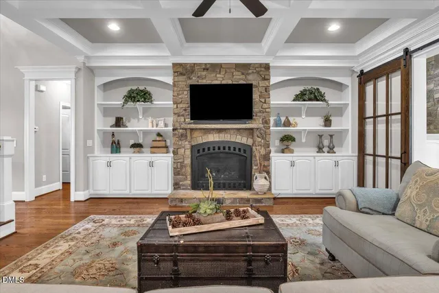 a kitchen with stainless steel appliances granite countertop a sink a stove a refrigerator and island with wooden floor