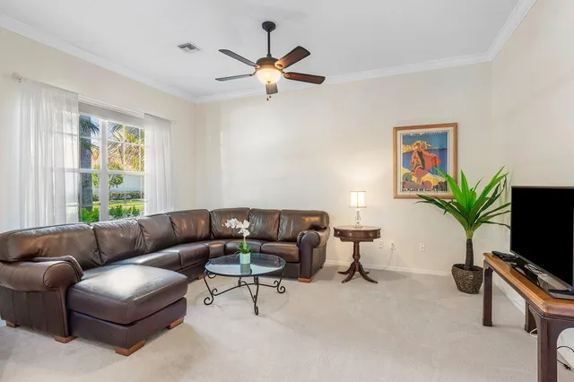 a bedroom with a bed a flat screen tv and a large window
