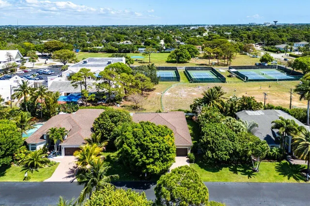 an aerial view of a house with a yard outdoor seating