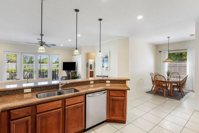 a kitchen with stainless steel appliances granite countertop a sink a stove and a refrigerator