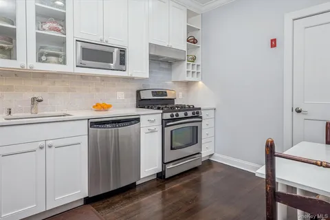 a kitchen with stainless steel appliances a stove a microwave and cabinets