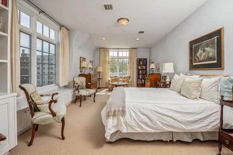 a bed room with a bed and a chair