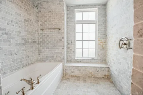 a bathroom with a bathtub and shower