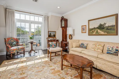 a living room with furniture large window and a table