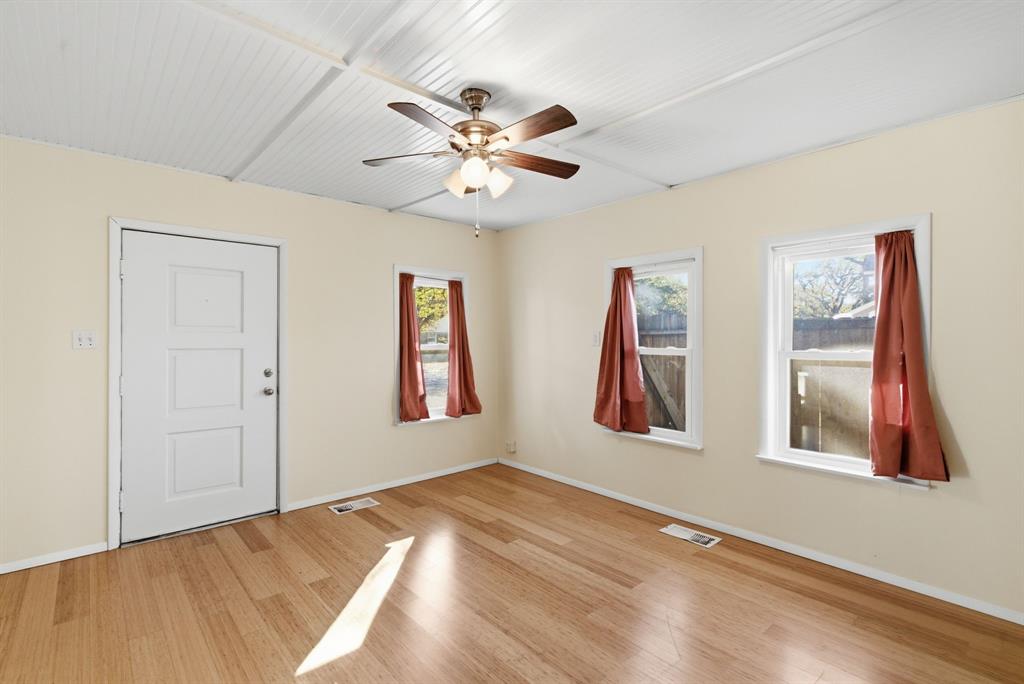 917 Carpenter Street Azle, TX 76020 - Photo 12 of 40 a view of an empty room with window and wooden floor