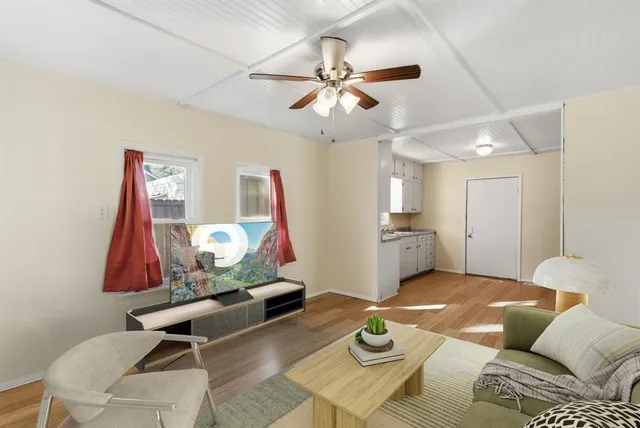 a living room with furniture and wooden floor