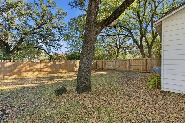 a backyard of a house with large trees