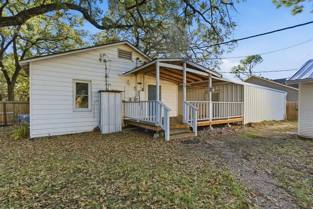 a view of a backyard with large trees