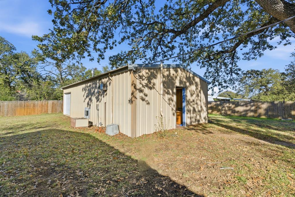 917 Carpenter Street Azle, TX 76020 - Photo 28 of 40 a view of a backyard with large trees