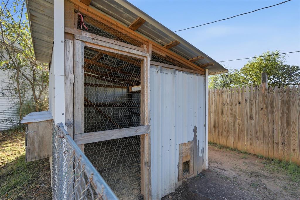 917 Carpenter Street Azle, TX 76020 - Photo 35 of 40 a view of a house with a small yard and wooden floor and fence
