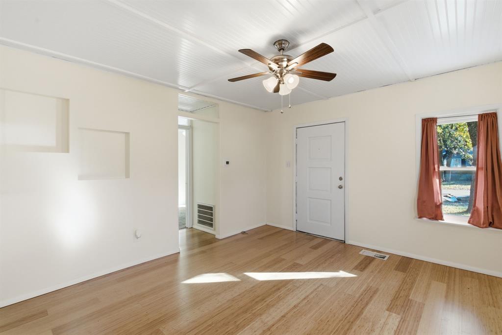 917 Carpenter Street Azle, TX 76020 - Photo 9 of 40 a view of empty room with wooden floor and window
