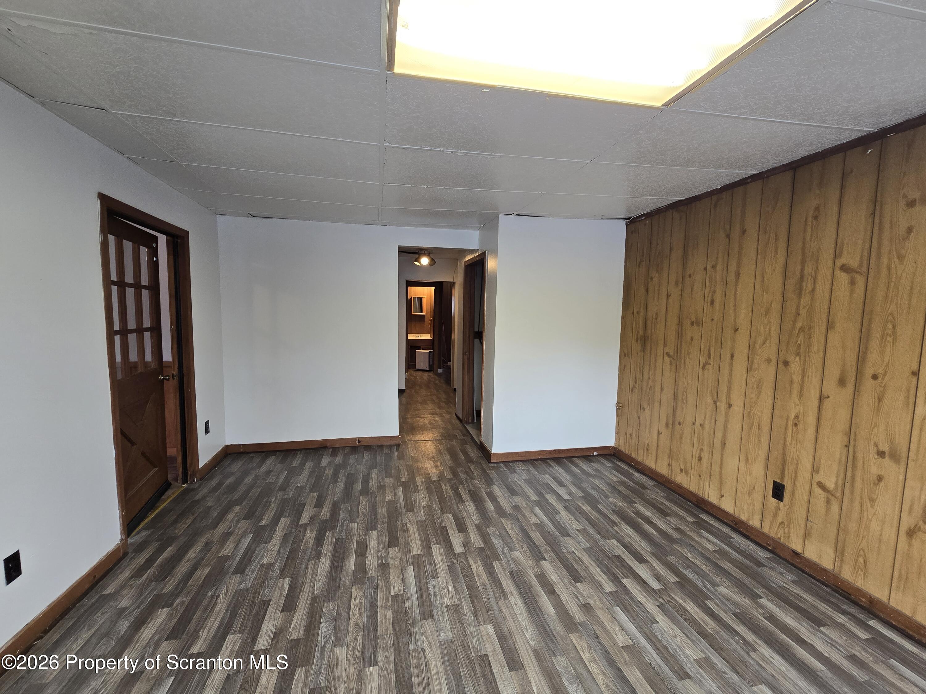 1025 Meshoppen Creek Road Tunkhannock, PA 18657 - Photo 14 of 24 a view of an empty room with wooden floor and a window