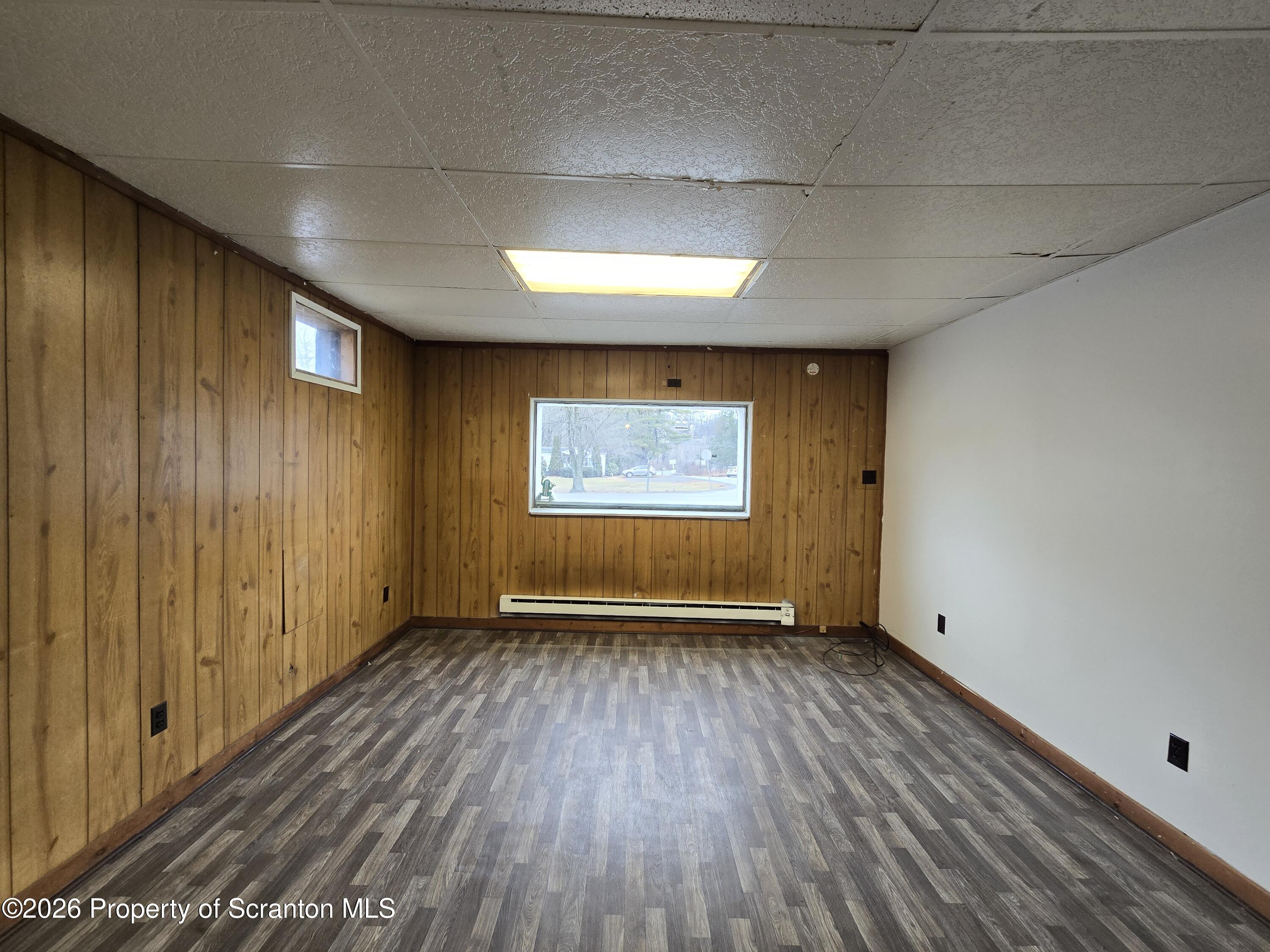 1025 Meshoppen Creek Road Tunkhannock, PA 18657 - Photo 15 of 24 an empty room with wooden floor and windows