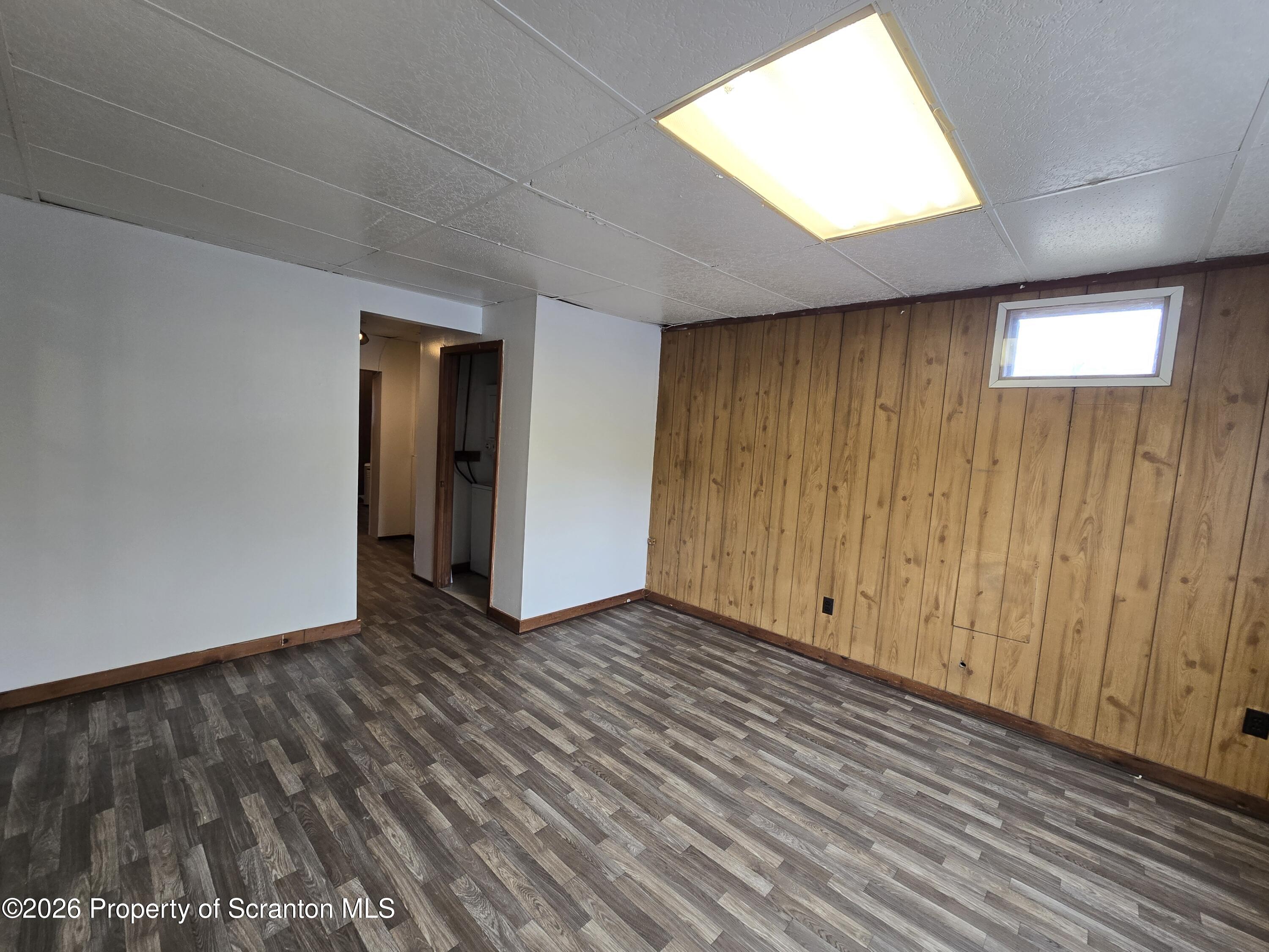 1025 Meshoppen Creek Road Tunkhannock, PA 18657 - Photo 16 of 24 a view of an empty room with wooden floor and a window