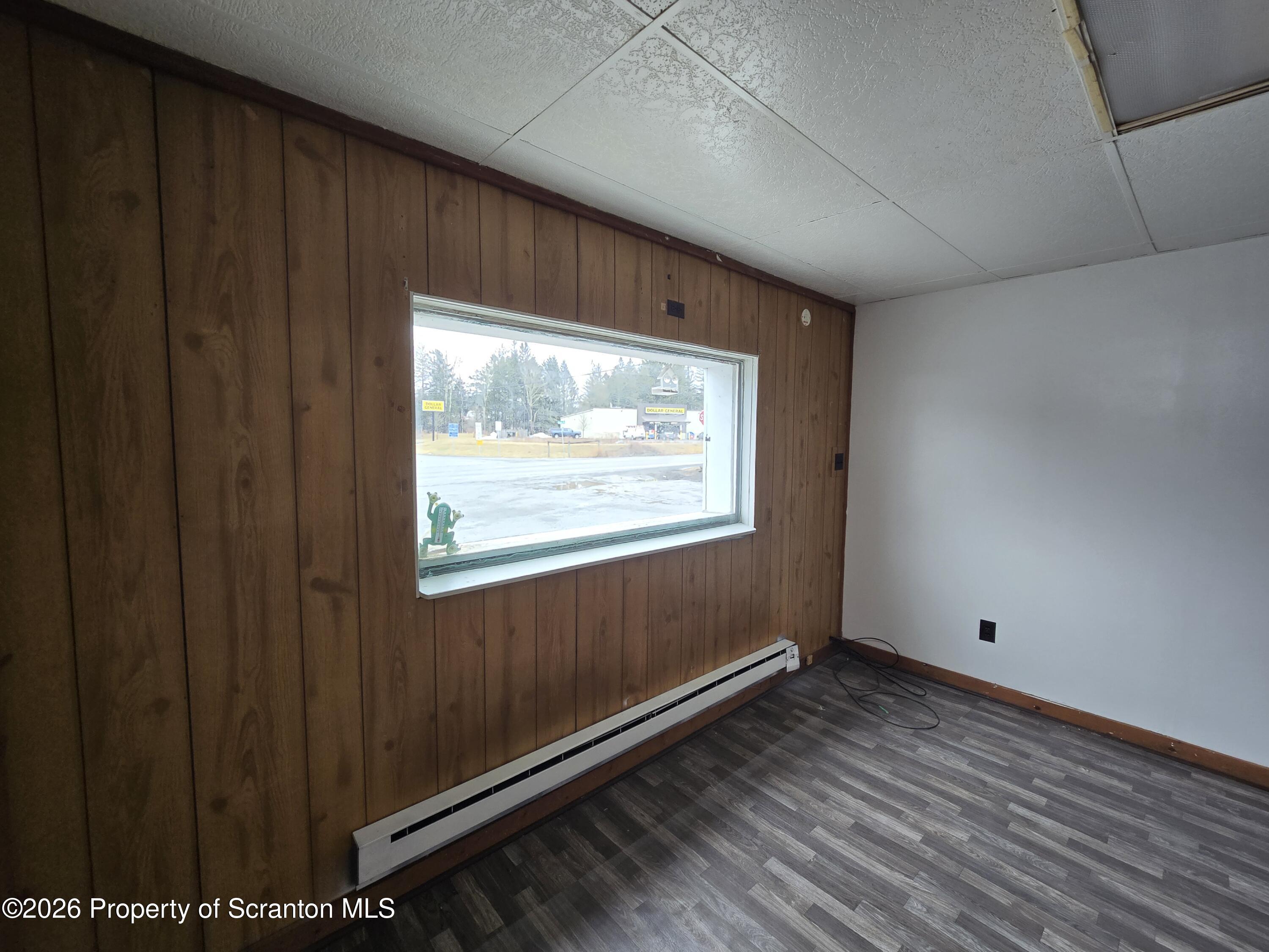 1025 Meshoppen Creek Road Tunkhannock, PA 18657 - Photo 17 of 24 a view of an empty room with wooden floor and a window