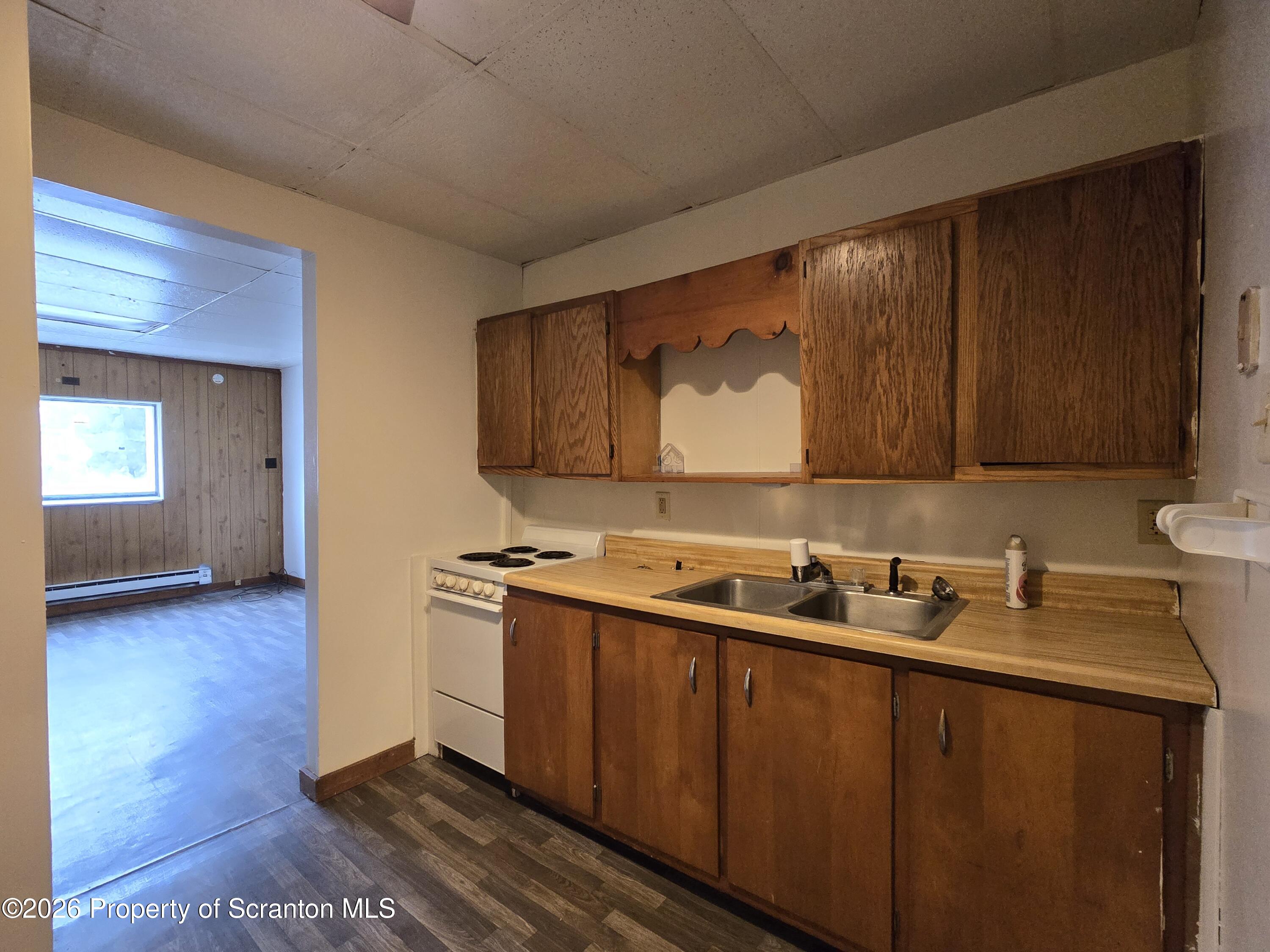 1025 Meshoppen Creek Road Tunkhannock, PA 18657 - Photo 19 of 24 a kitchen with a sink cabinets and wooden floor