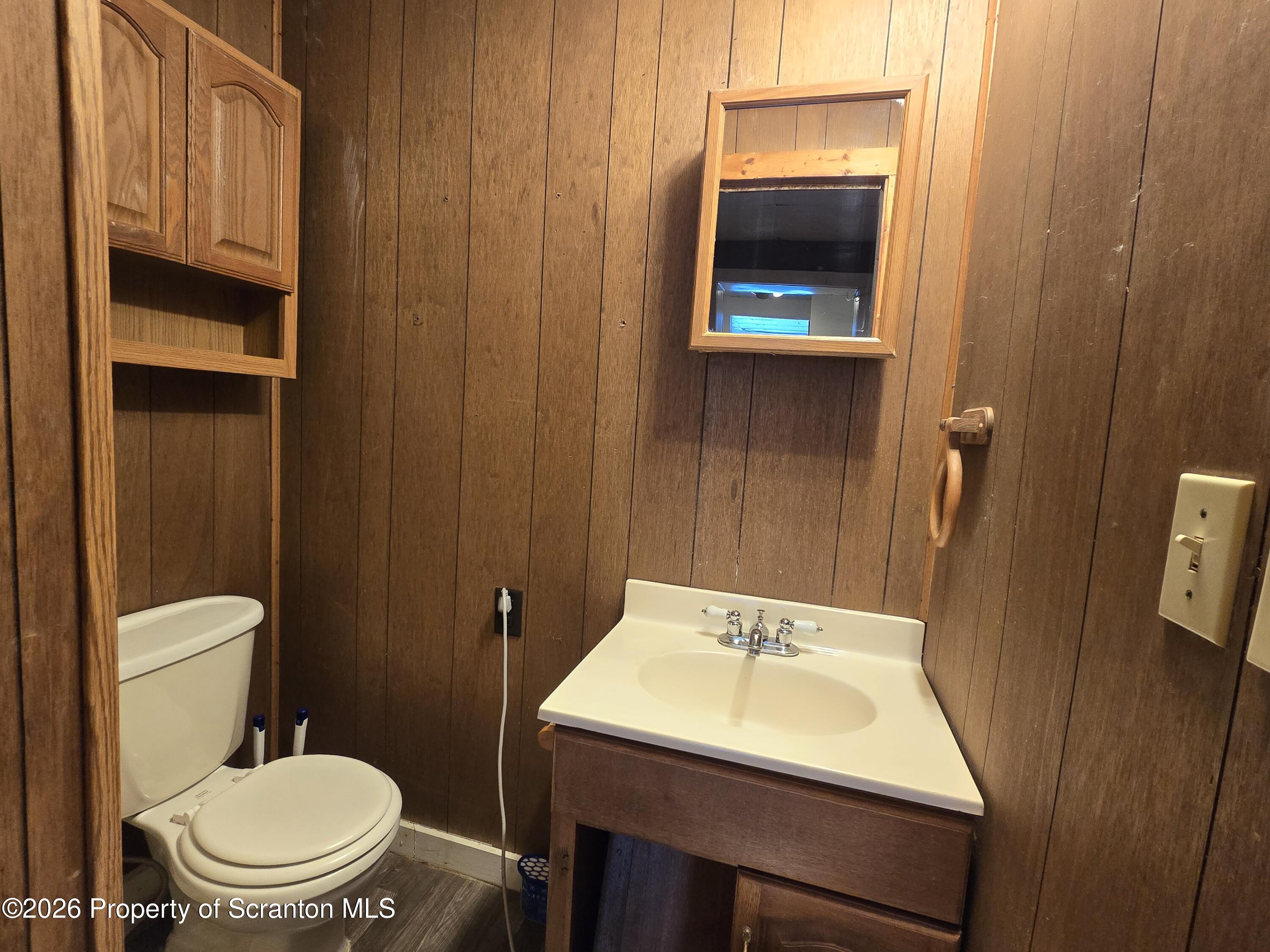 1025 Meshoppen Creek Road Tunkhannock, PA 18657 - Photo 20 of 24 a bathroom with a toilet a sink and mirror