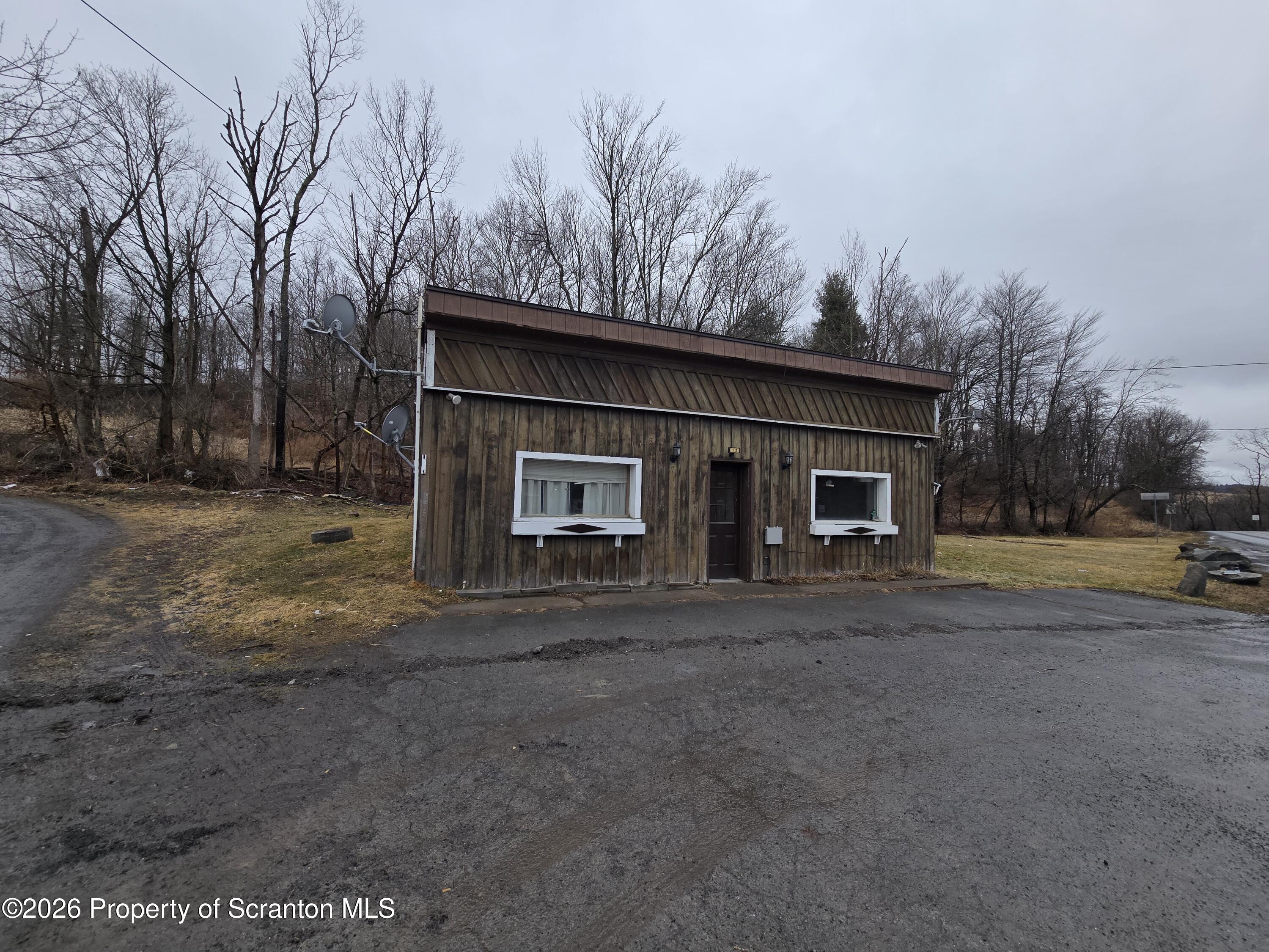 1025 Meshoppen Creek Road Tunkhannock, PA 18657 - Photo 2 of 24 a front view of a house with a yard and garage