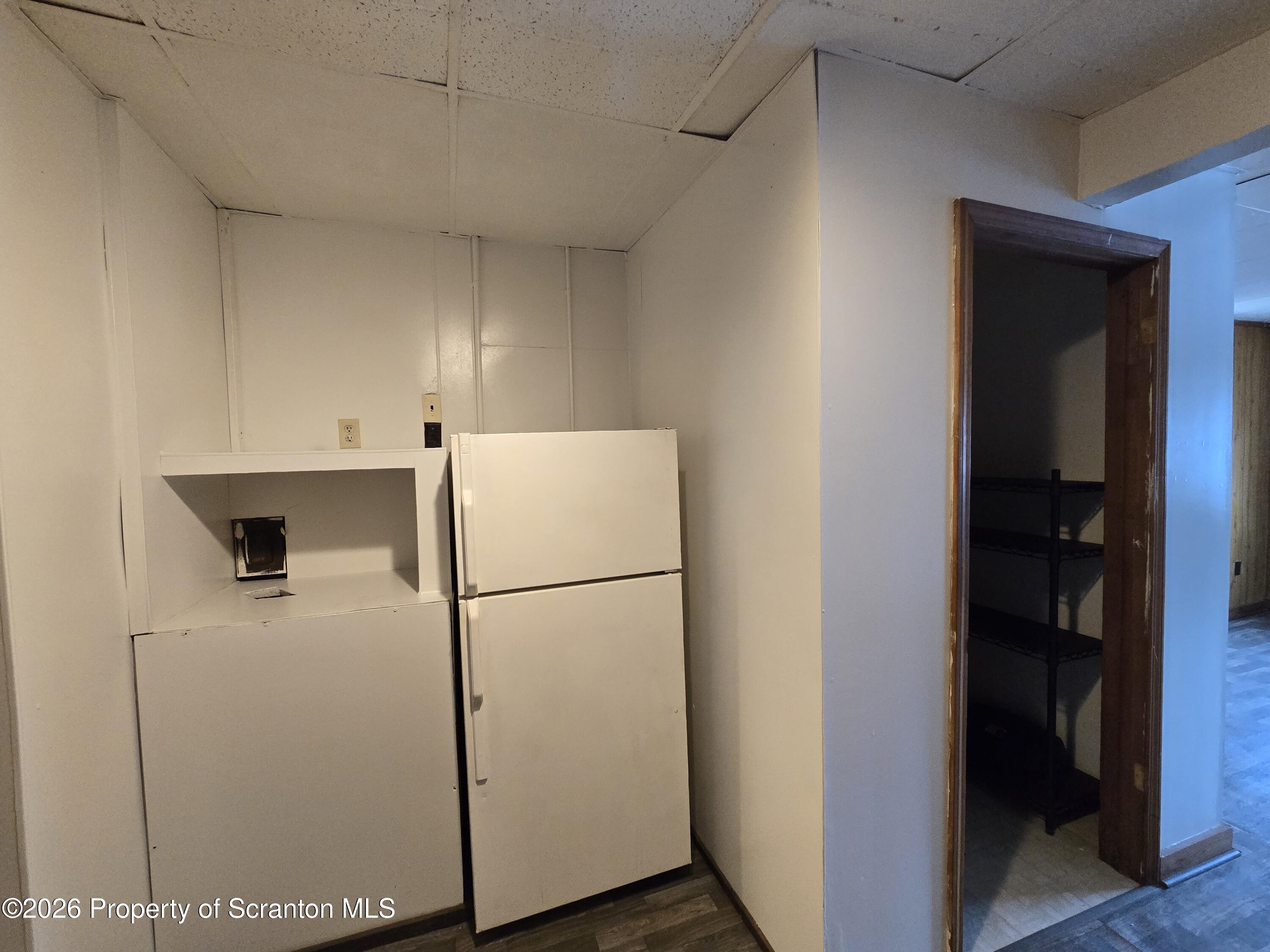 1025 Meshoppen Creek Road Tunkhannock, PA 18657 - Photo 21 of 24 a white refrigerator freezer and a stove sitting inside of a room