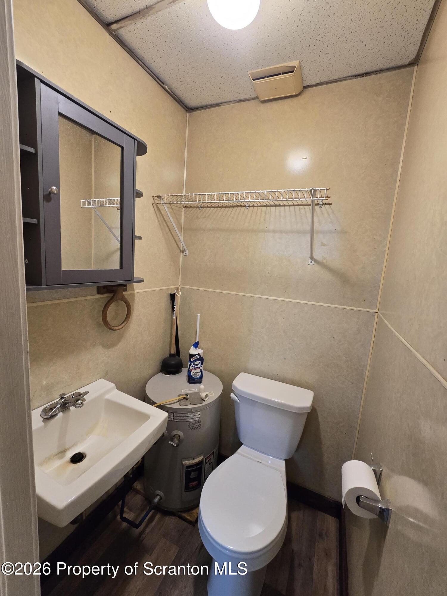 1025 Meshoppen Creek Road Tunkhannock, PA 18657 - Photo 24 of 24 a bathroom with a toilet a sink and mirror