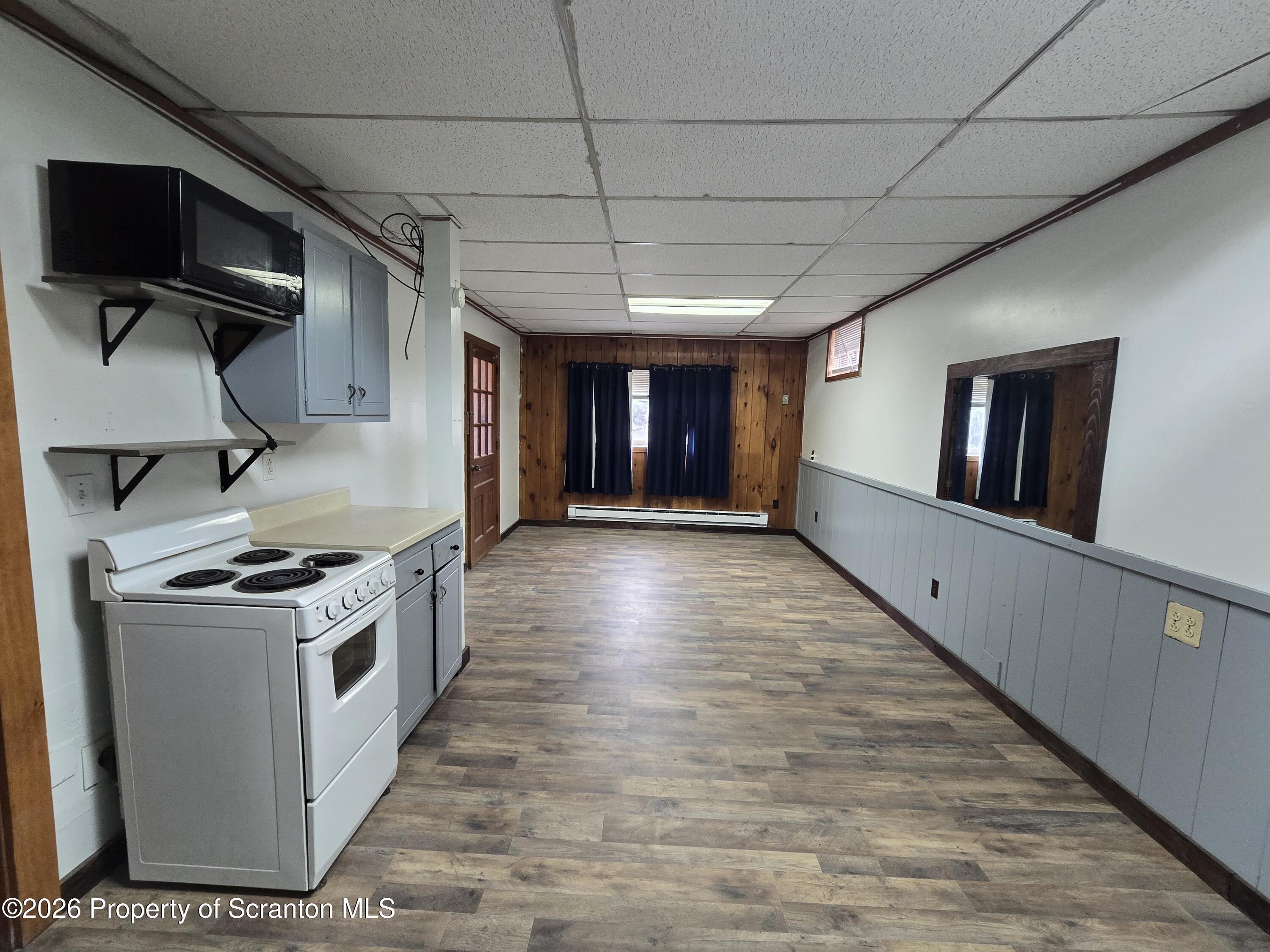 1025 Meshoppen Creek Road Tunkhannock, PA 18657 - Photo 10 of 24 a kitchen with stove and wooden floor