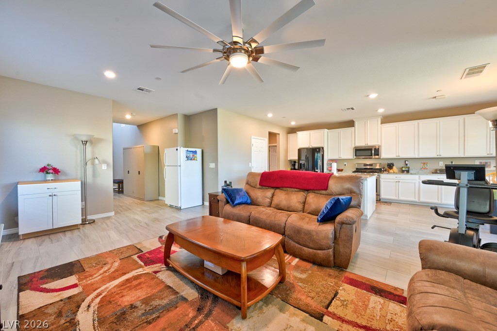 1054 Langston Ranch Avenue Henderson, NV 89002 - Photo 17 of 82 Living area with a lighted ceiling fan. Very large room that can fit large furniture.