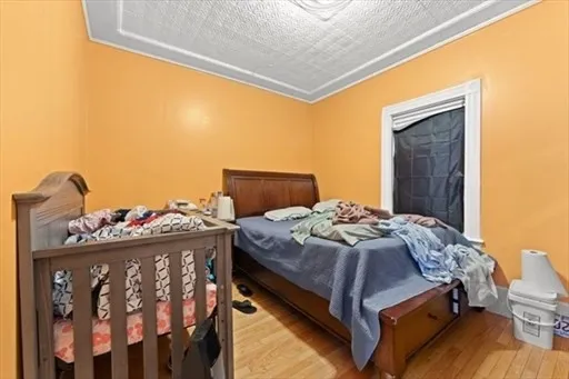 a bed sitting in a bedroom next to a window