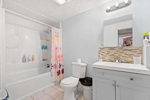 a kitchen with a stove sink and cabinets