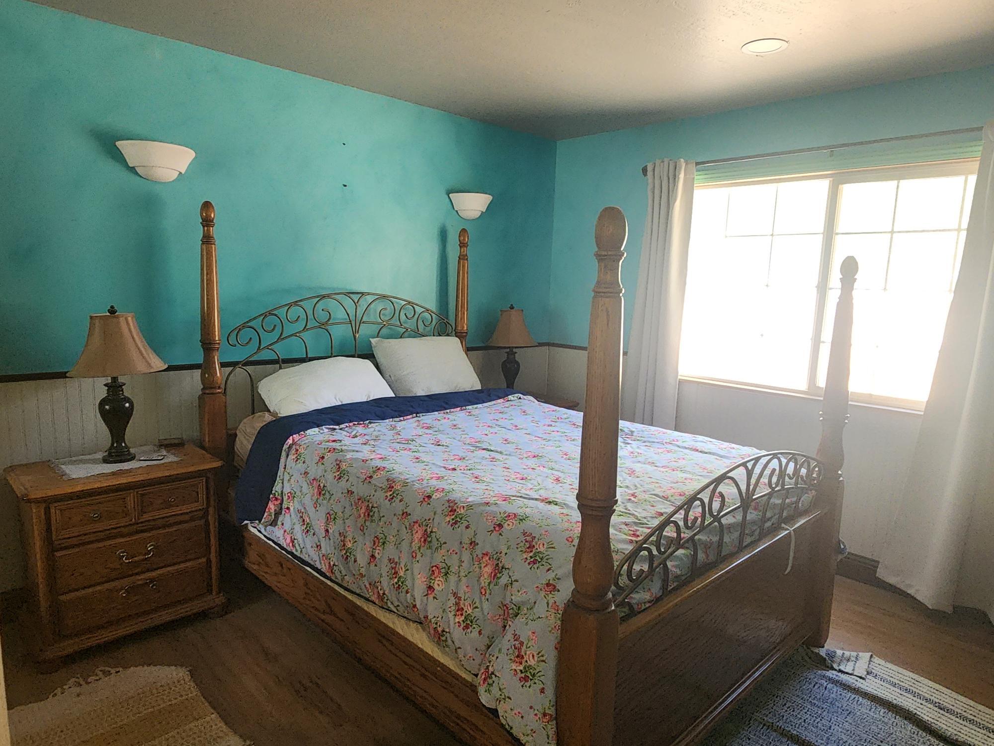 20263 Sugar Pine Street Burney, CA 96013 - Photo 15 of 22 a bed sitting in a bedroom next to a window