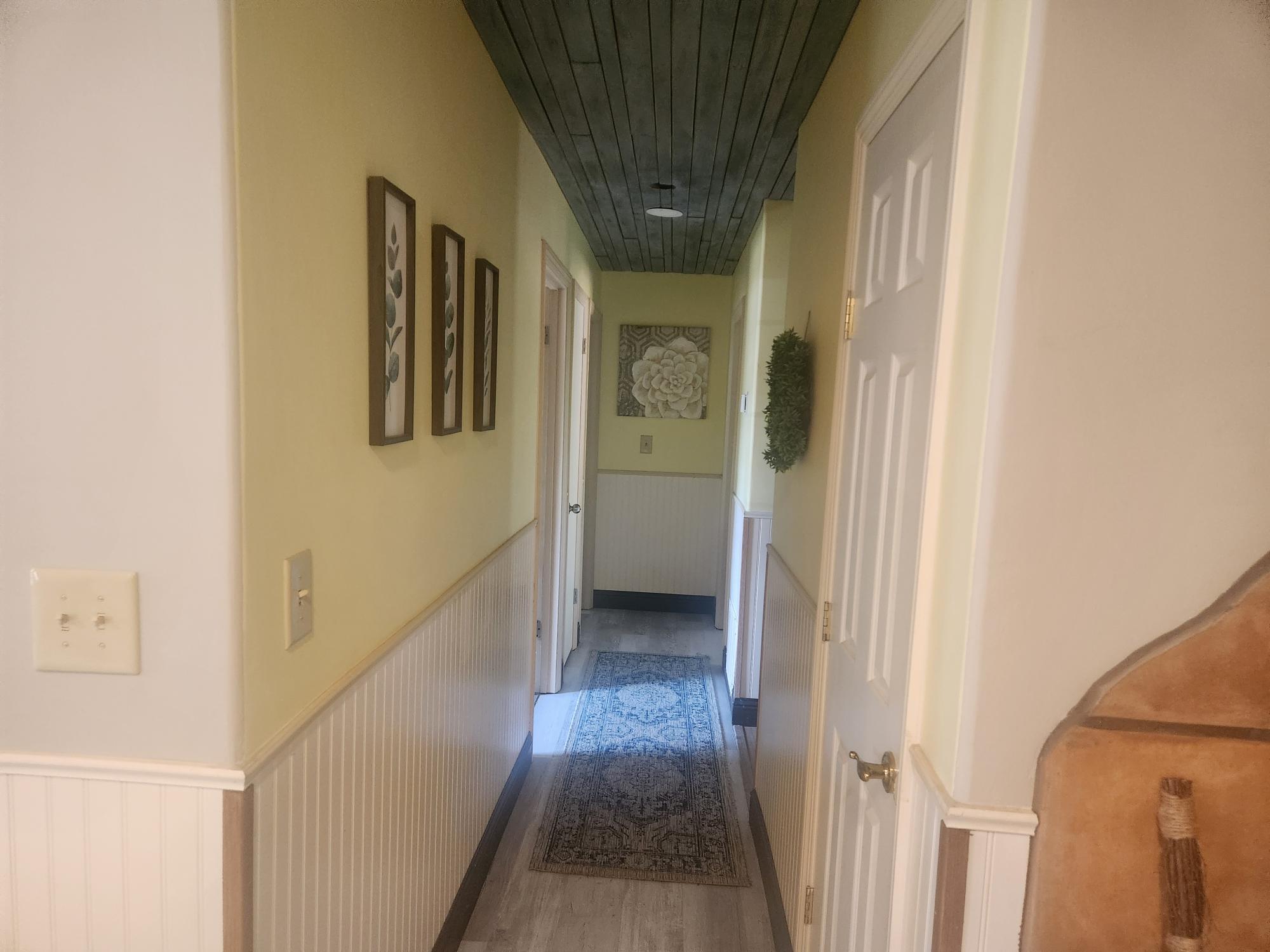 20263 Sugar Pine Street Burney, CA 96013 - Photo 9 of 22 a view of a hallway with wooden floor and staircase