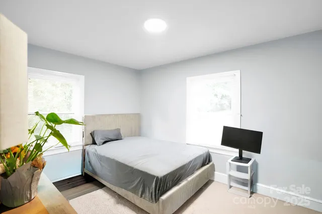 a bed room with a bed window and a chair