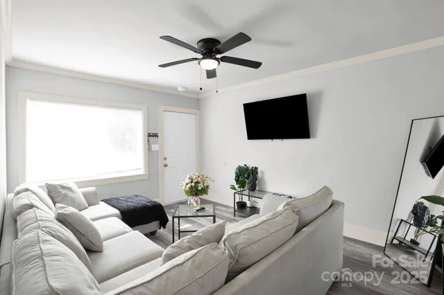 a living room with furniture and a flat screen tv