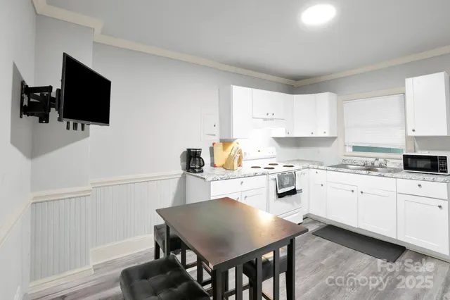 a kitchen with white cabinets stainless steel appliances and sink
