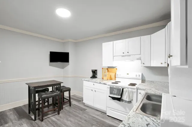 a view of kitchen with sink microwave and cabinets