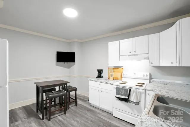 a kitchen with a sink appliances and cabinets