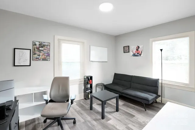 a living room with furniture a couch and a window